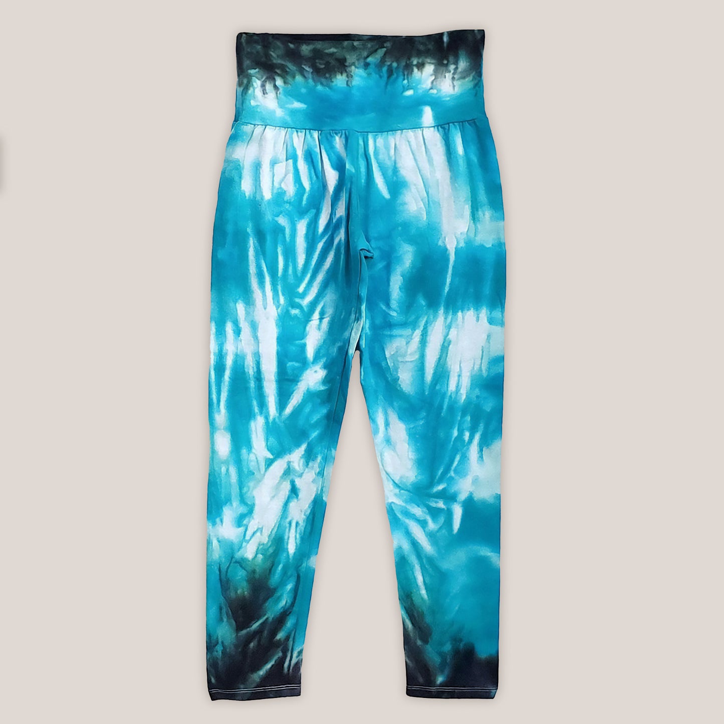 Teal tie dye yoga leggings with a wide waistband.