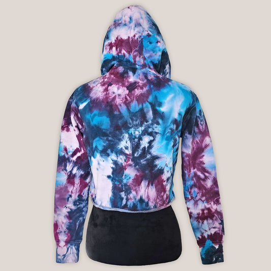 Tie-dye hoodie with a colorful pattern on a beige background