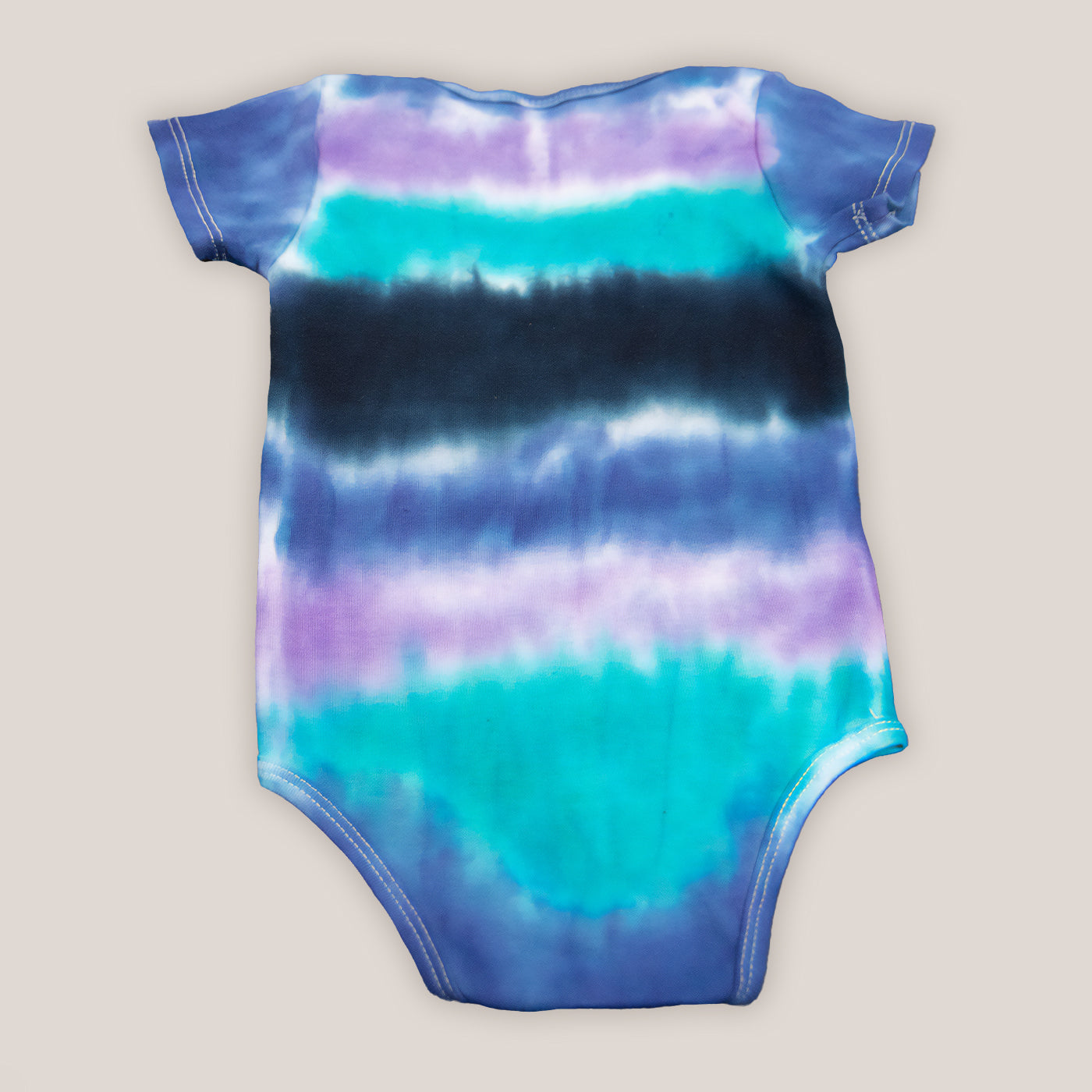 Blue, teal, and black baby bodysuit and hat.