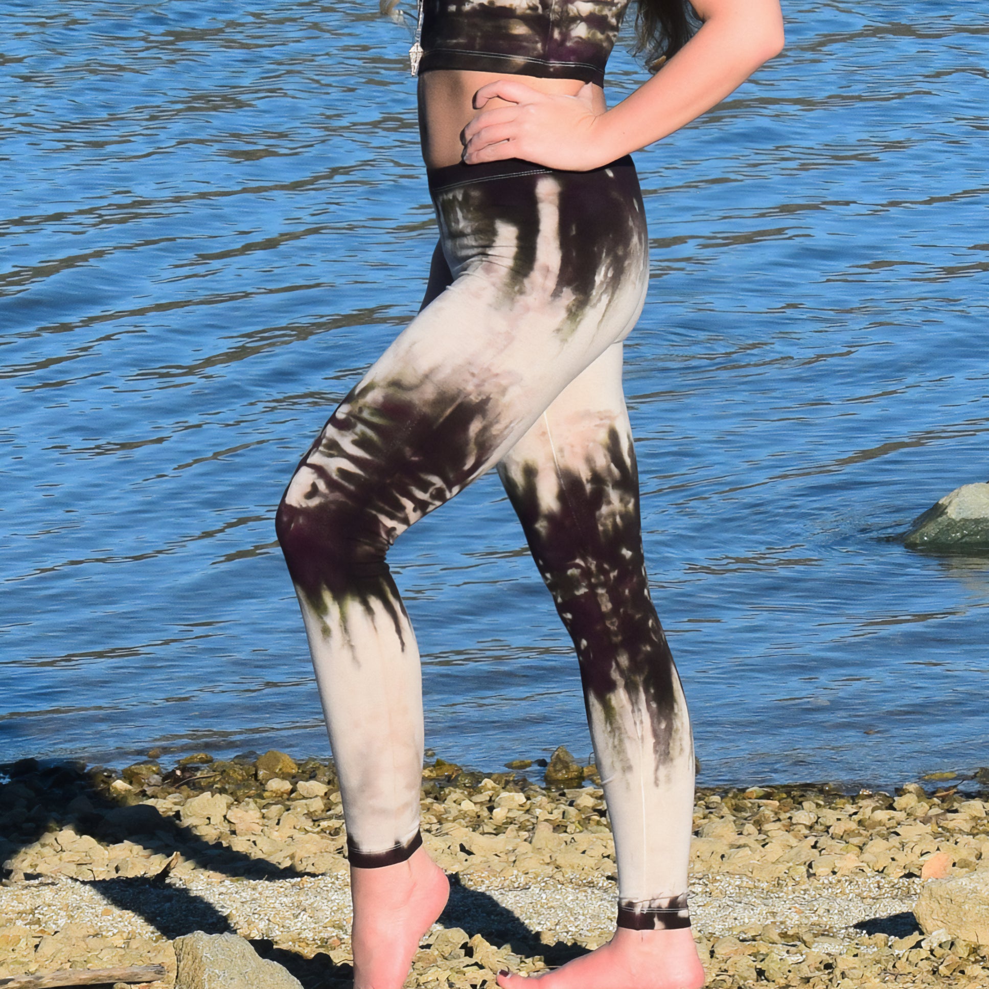 Woman wearing a pair of tie dye leggings by Akasha Sun in the colors cream and dark brown.