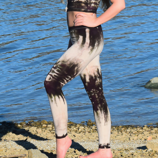 Woman wearing a pair of tie dye leggings by Akasha Sun in the colors cream and dark brown.