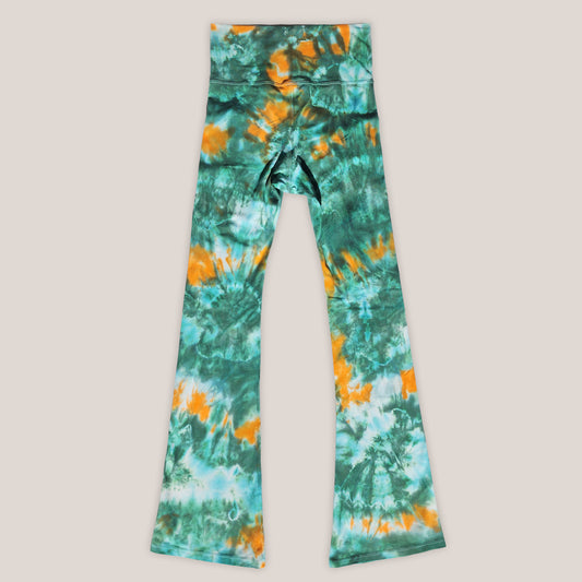 Tie-dye leggings with green and orange pattern on a light gray background