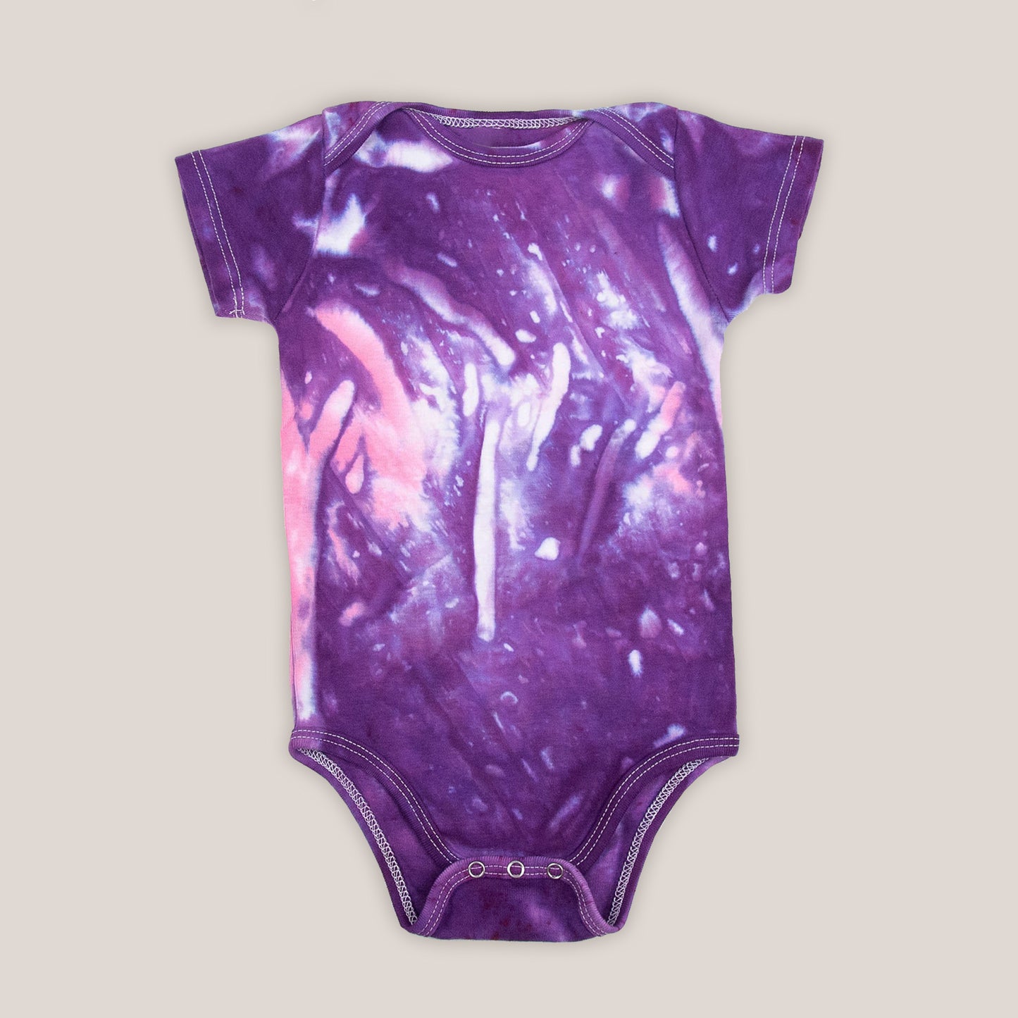 Purple and pink tie dye bodysuit by Akasha Sun. Made of organic cotton.