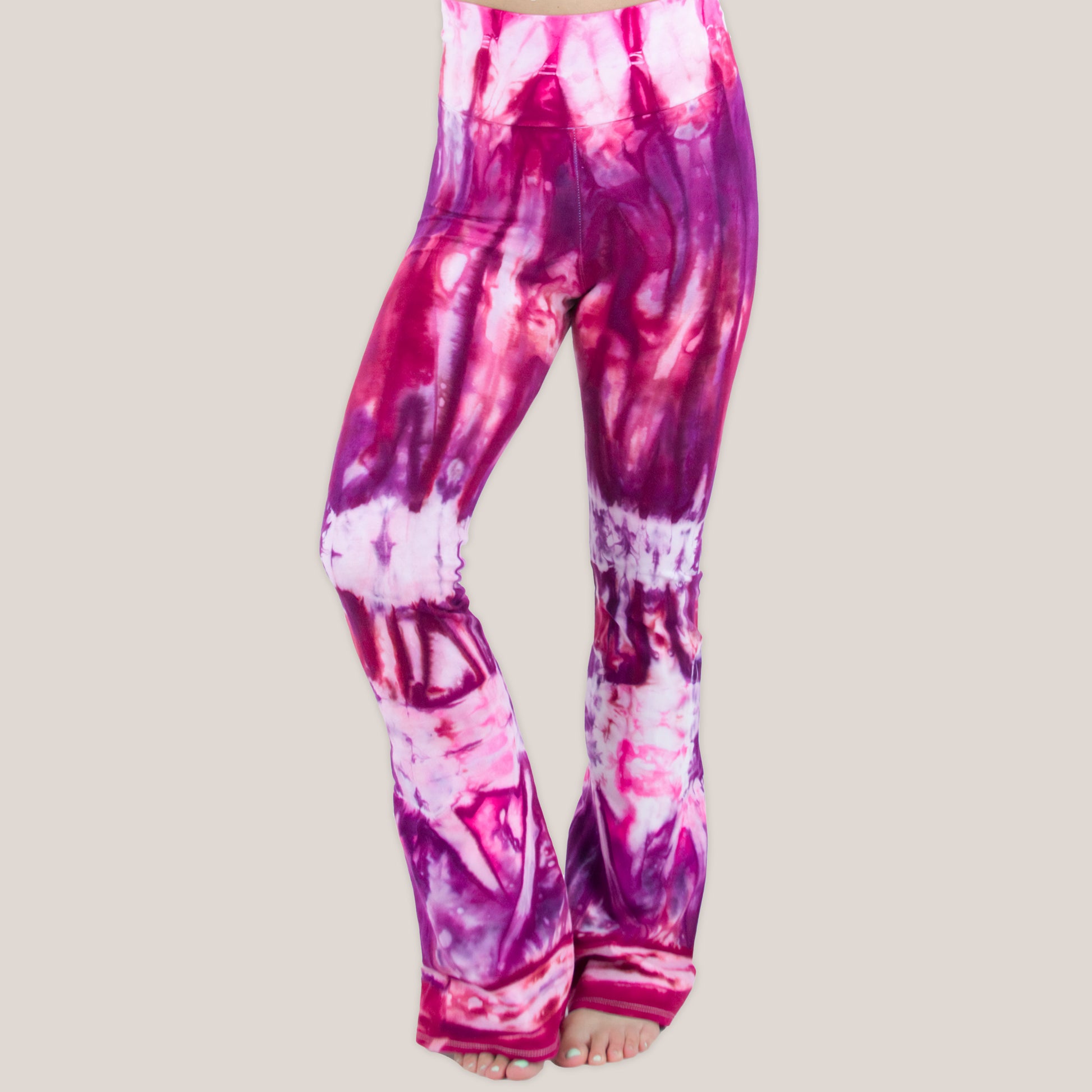 Pink, red, and purple tie dye yoga pants with a wide waistband by Akasha Sun.