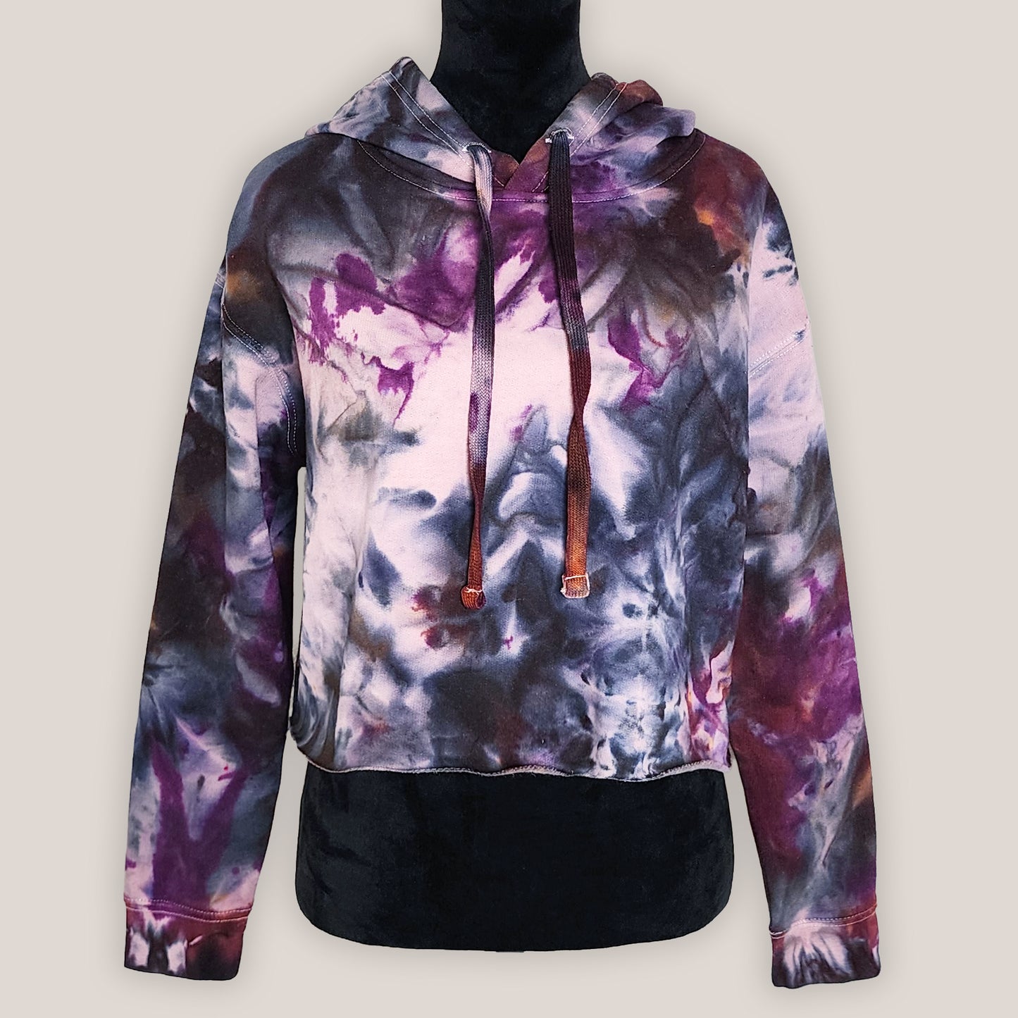 Multicolored tie-dye hoodie on a plain background