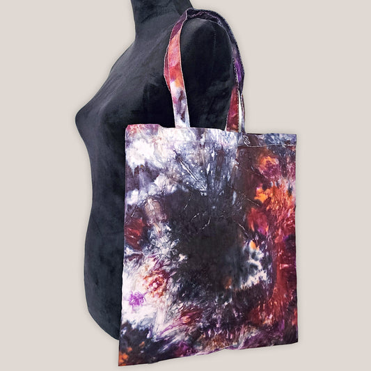 Tote bag with abstract multicolor design on a plain background