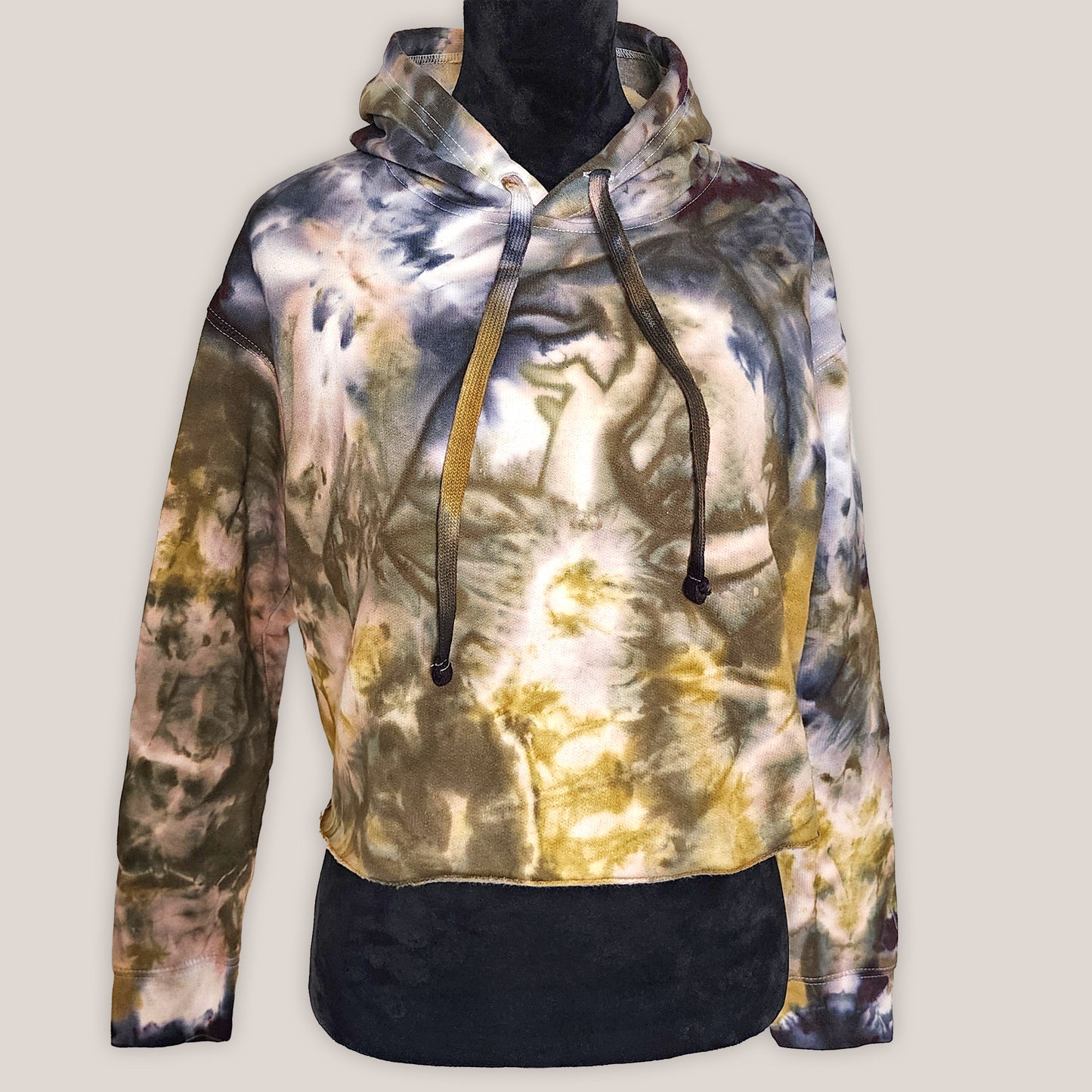 Tie-dye hoodie on a mannequin against a plain background