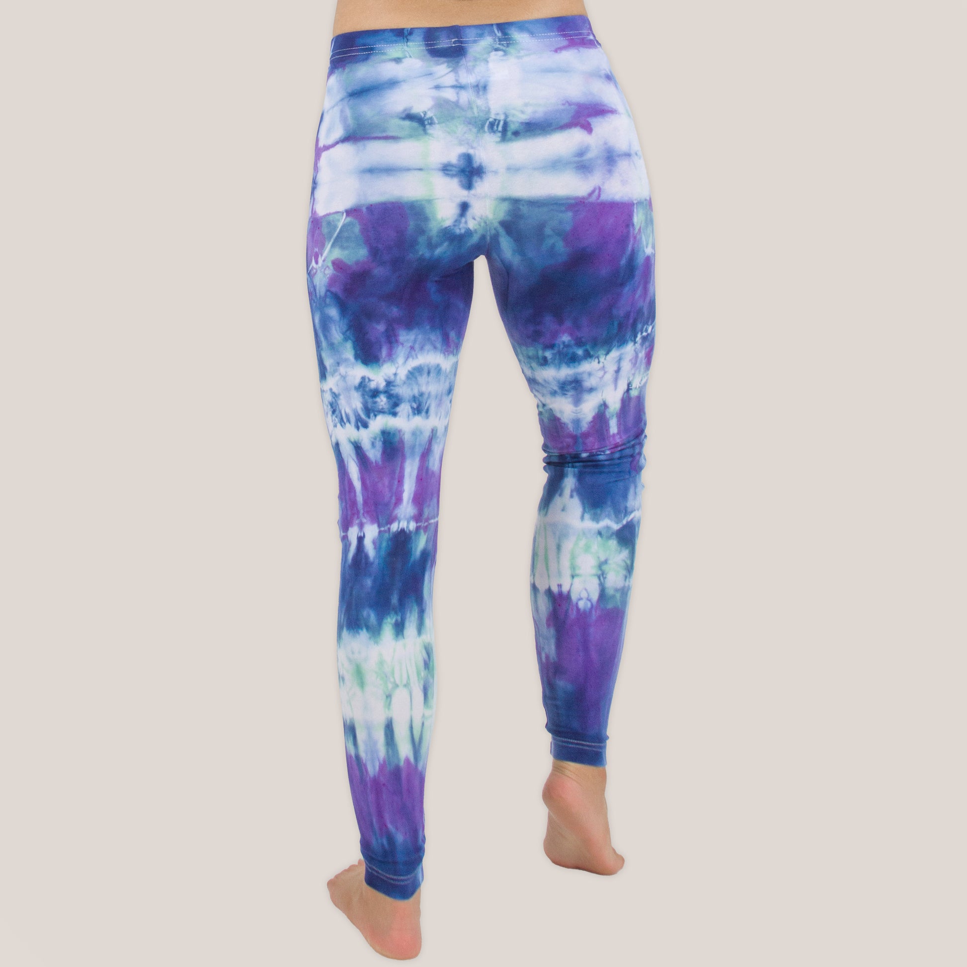 Woman wearing the Mykonos tie dye leggings with the color blue, purple, light teal, and white by Akasha Sun