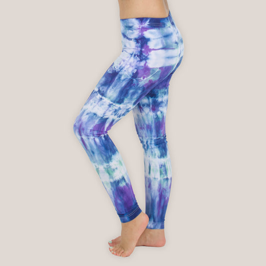 Woman wearing the Mykonos tie dye leggings with the color blue, purple, light teal, and white by Akasha Sun