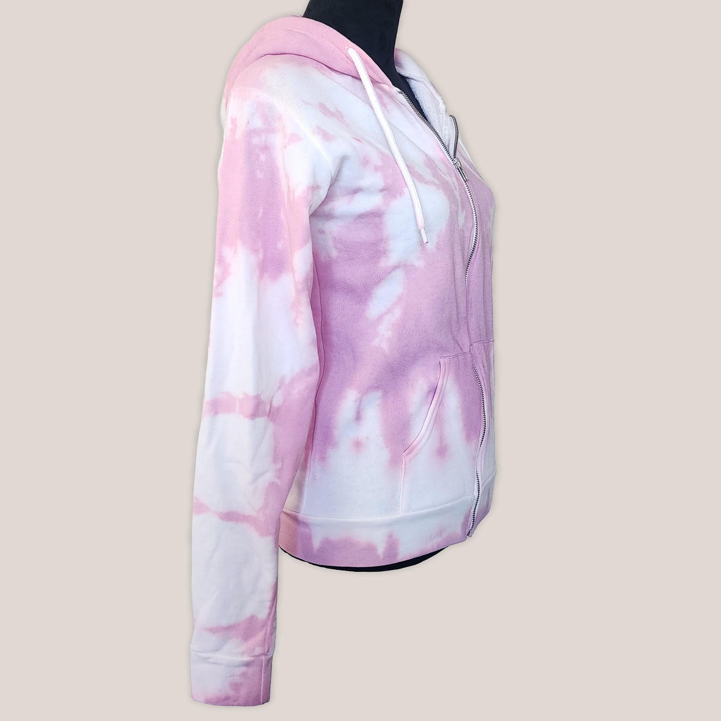 Pink and white tie-dye hoodie on a mannequin against a beige background