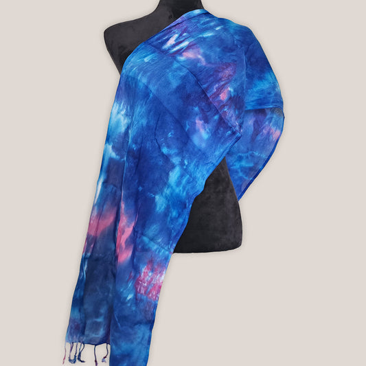 Blue and pink tie-dye scarf on a mannequin against a plain background