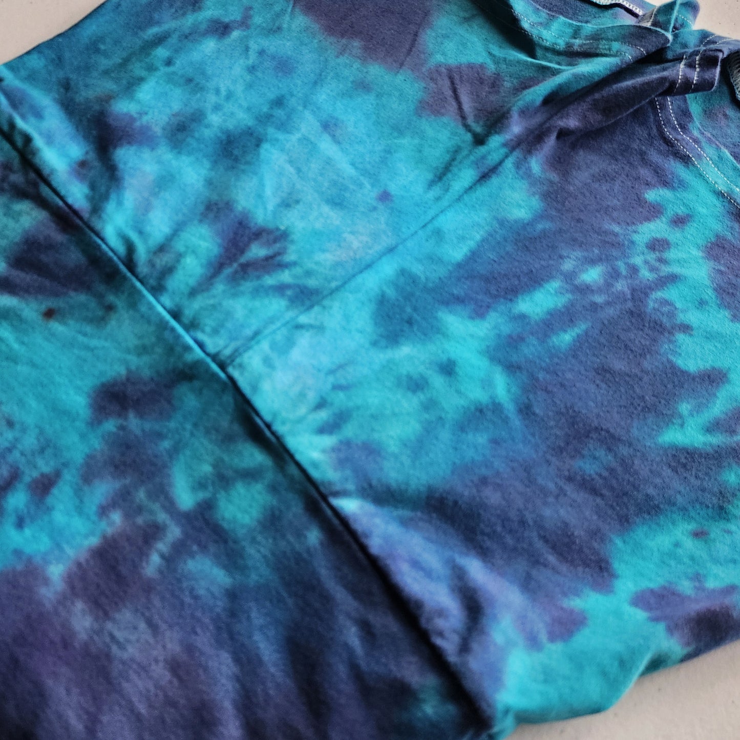 Blue and purple tie-dye shirt on a plain background