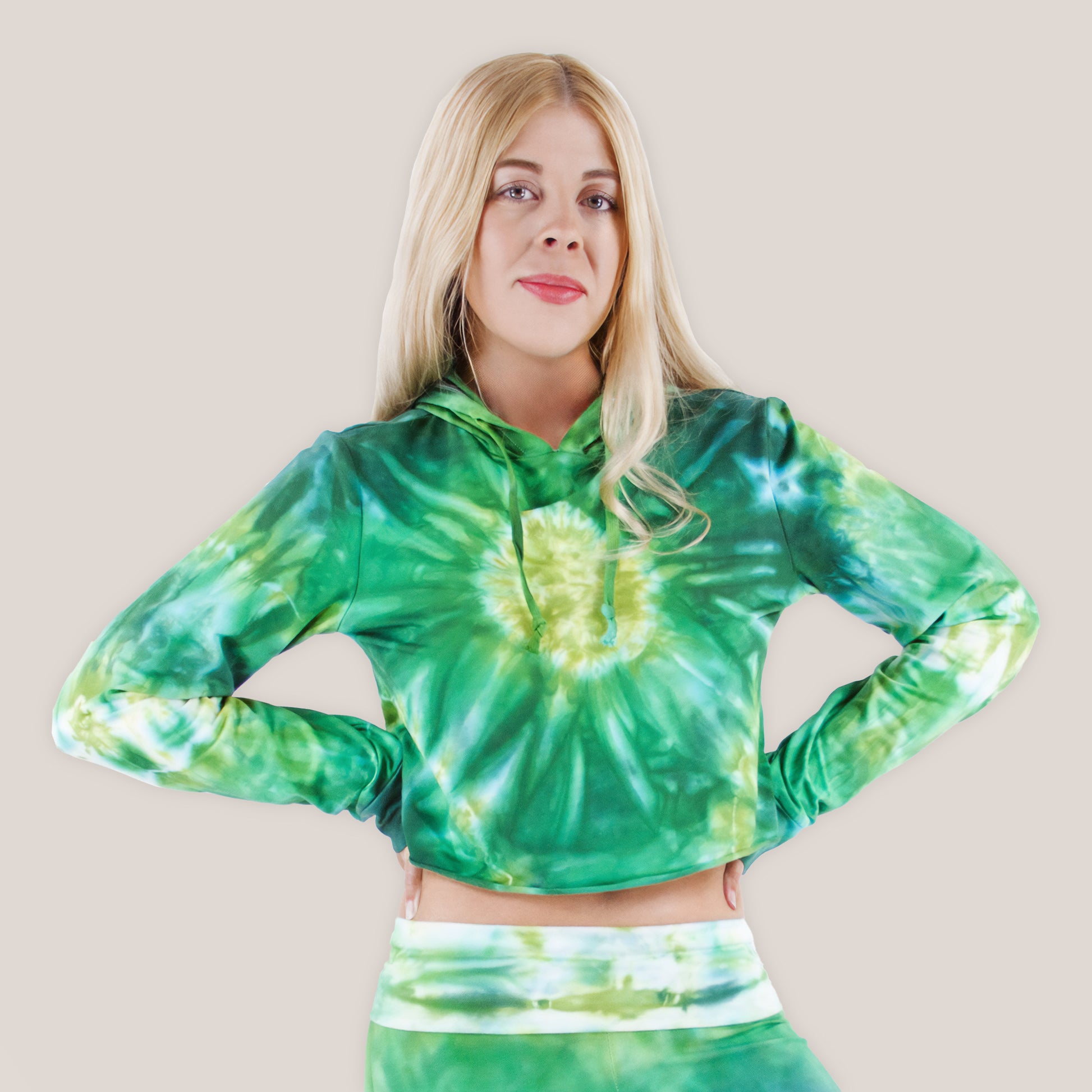 Woman wearing an Akasha Sun green tie dye crop top with a hood.