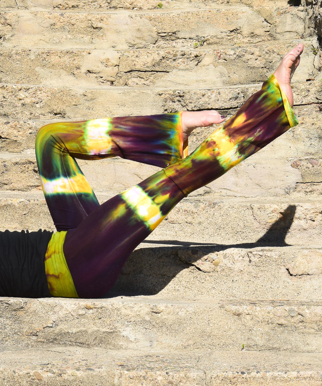 Green + purple cotton spandex tie dye yoga pants with a fold over waistband.