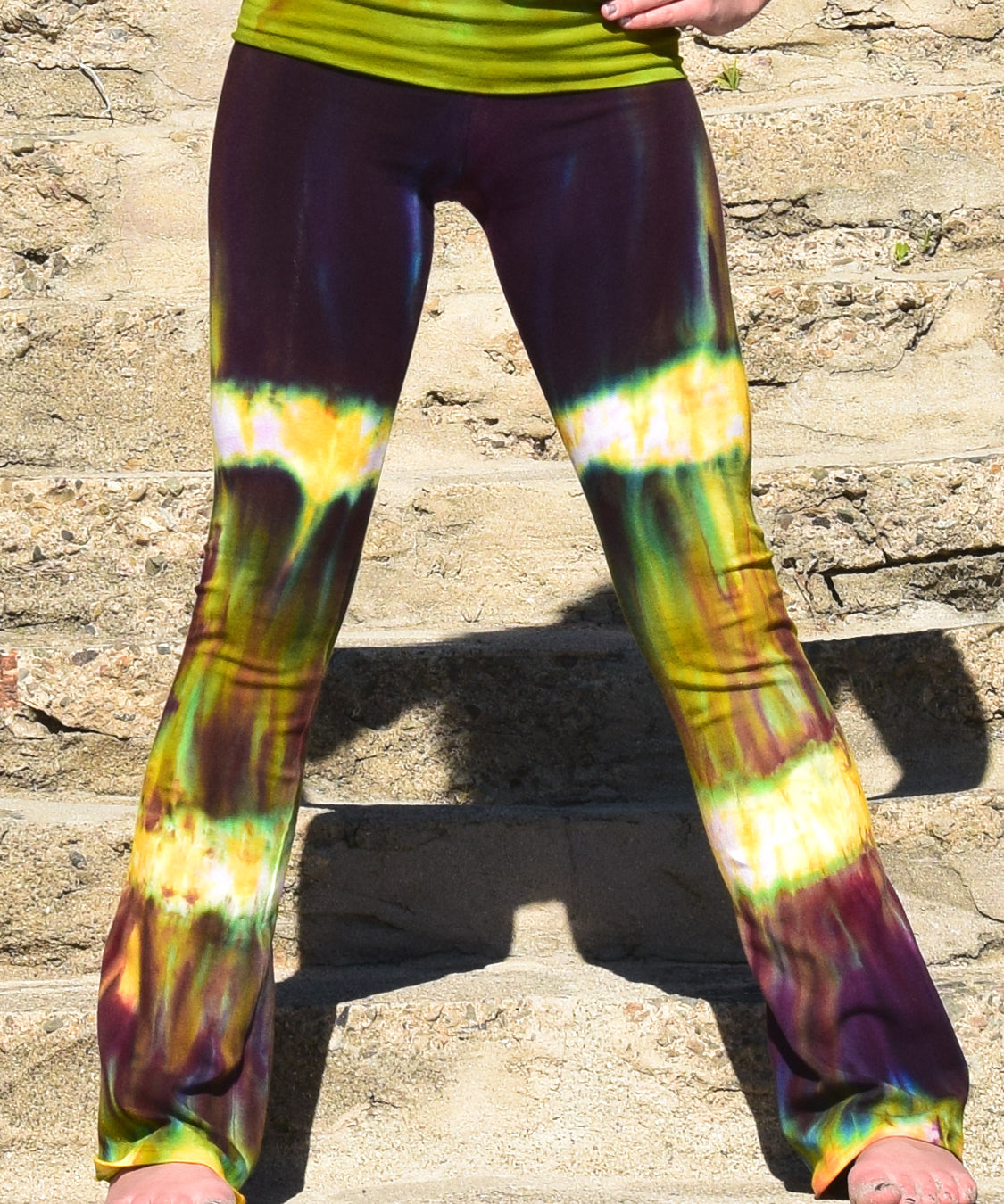Green + purple cotton spandex tie dye yoga pants with a fold over waistband.