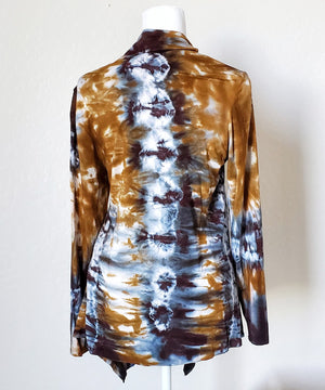 An amber and black tie dye cardigan featuring a waterfall drape in the front and long sleeves.