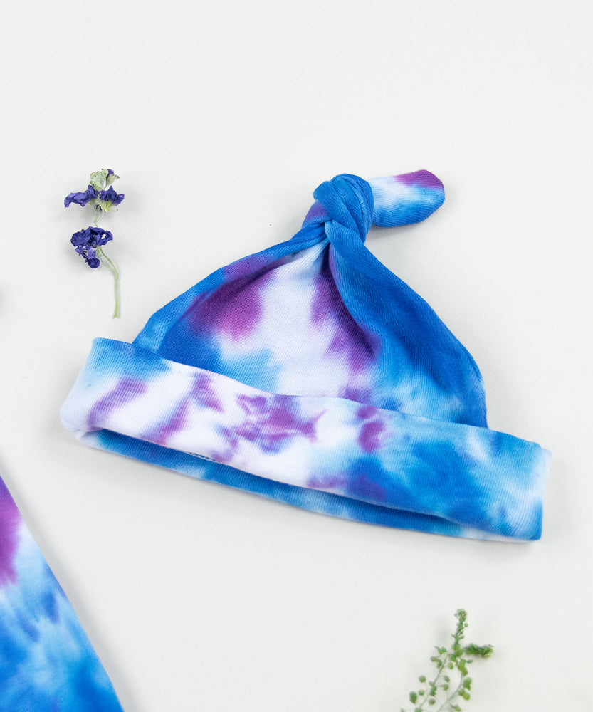 Blue and purple tie dye organic baby bodysuit, hat, and blanket by Akasha Sun.