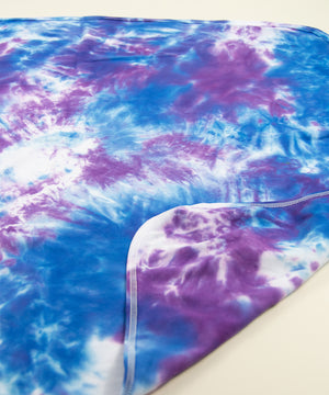 Blue and purple tie dye organic baby bodysuit, hat, and blanket by Akasha Sun.