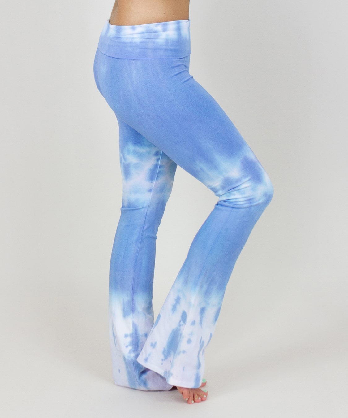 Woman wearing a pair of blue and white fold over yoga pants made of sustainable cotton.