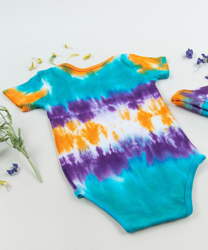 Teal, purple, and orange tie dye organic cotton bodysuit and baby hat set by Akasha Sun.