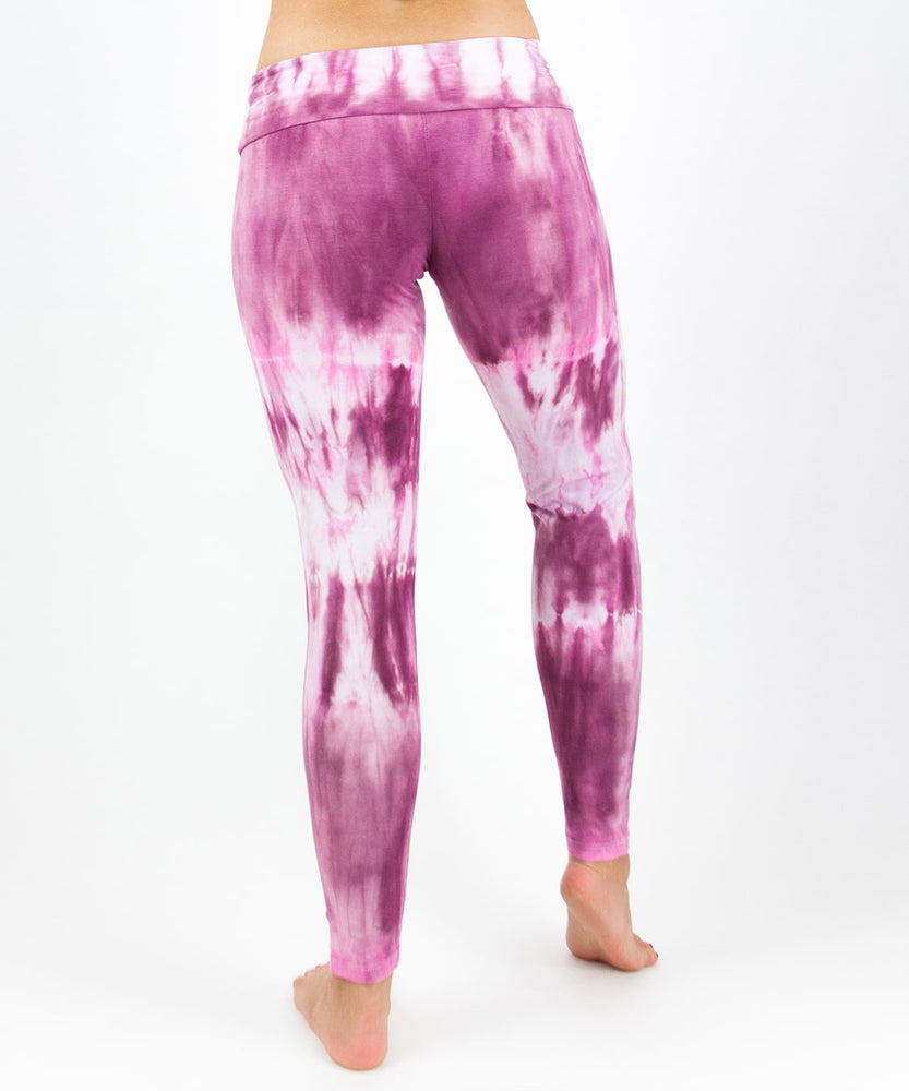 Woman wearing a pair of pink tie dye fold over leggings by Akasha Sun.