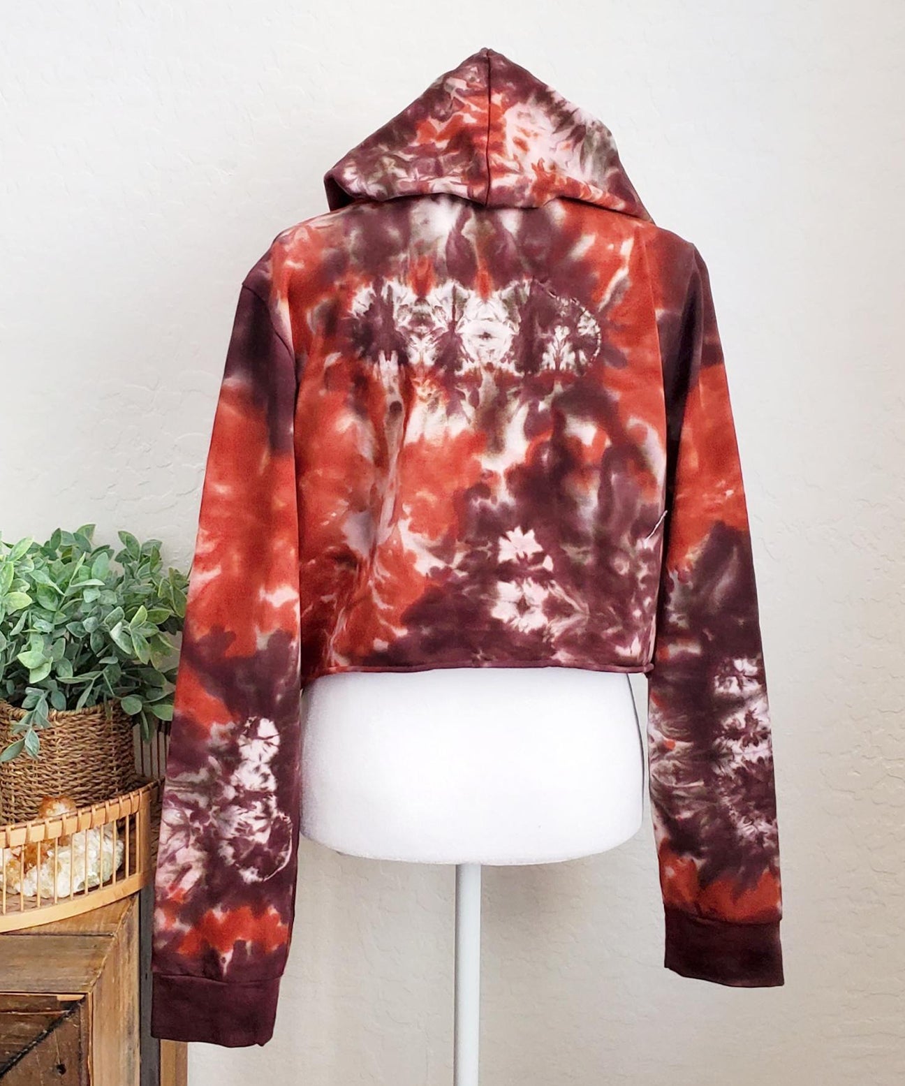 Rustic red and brown tie dye hoodie crop top with long sleeves.