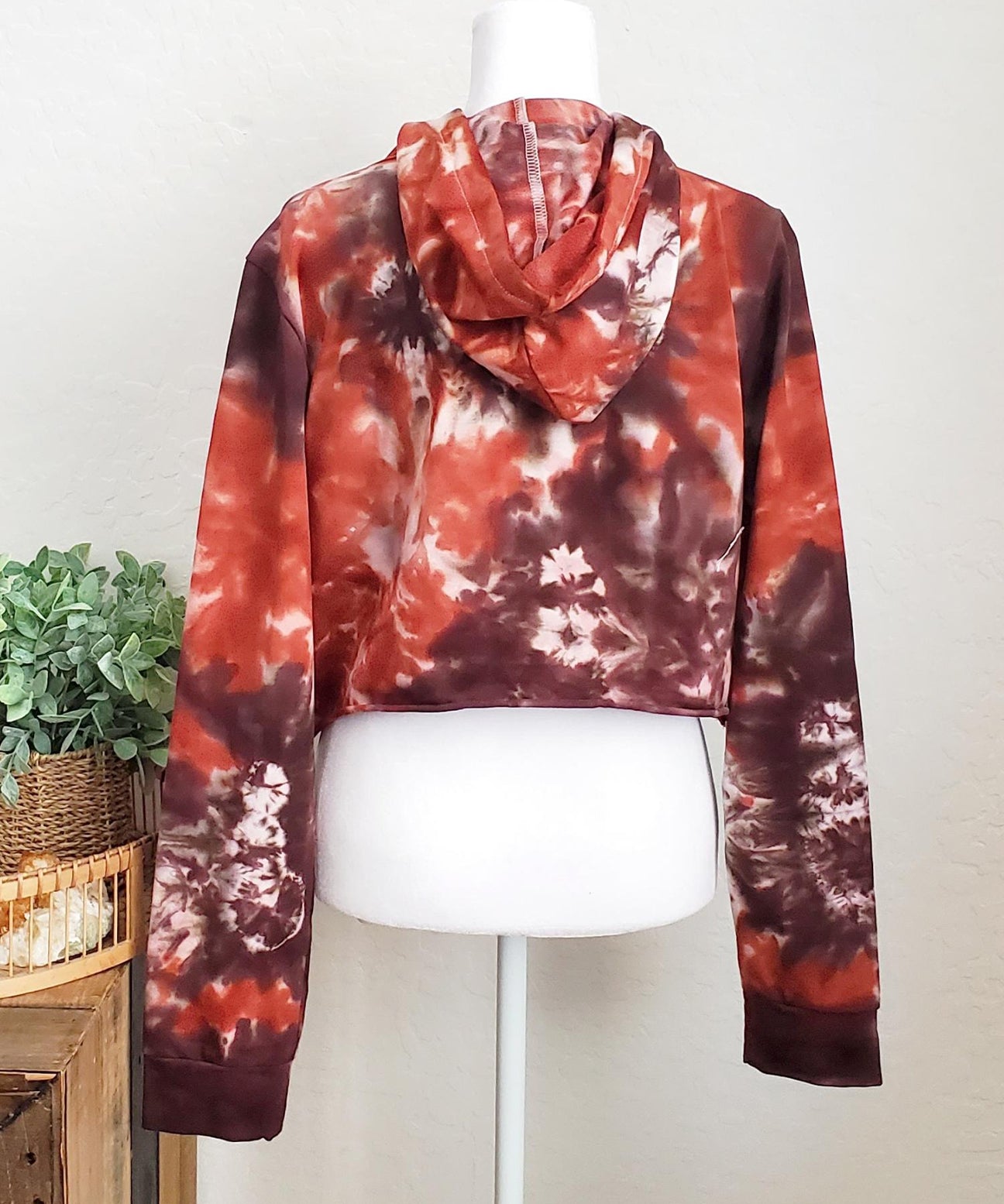 Rustic red and brown tie dye hoodie crop top with long sleeves.