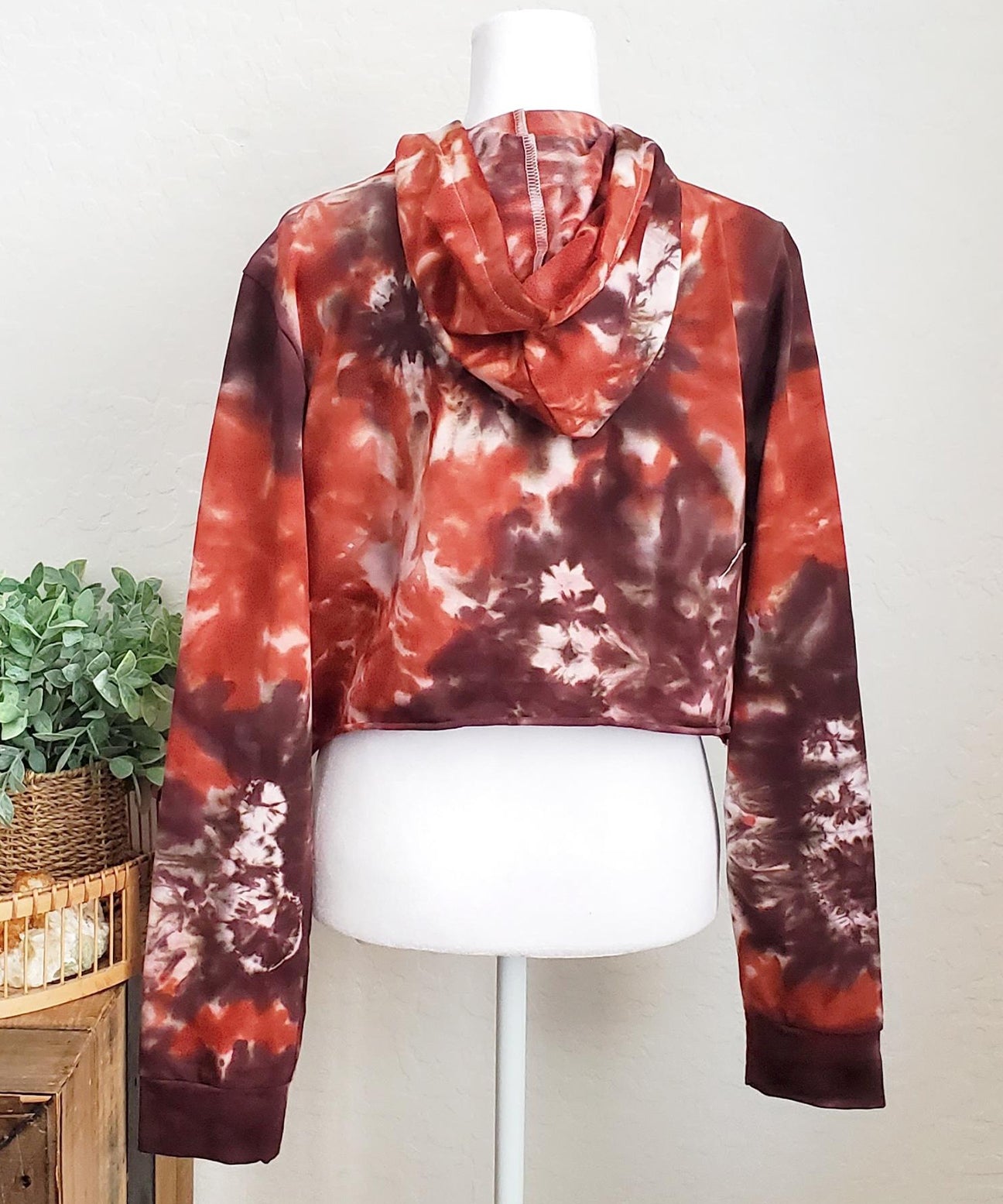 Rustic red and brown tie dye hoodie crop top with long sleeves.