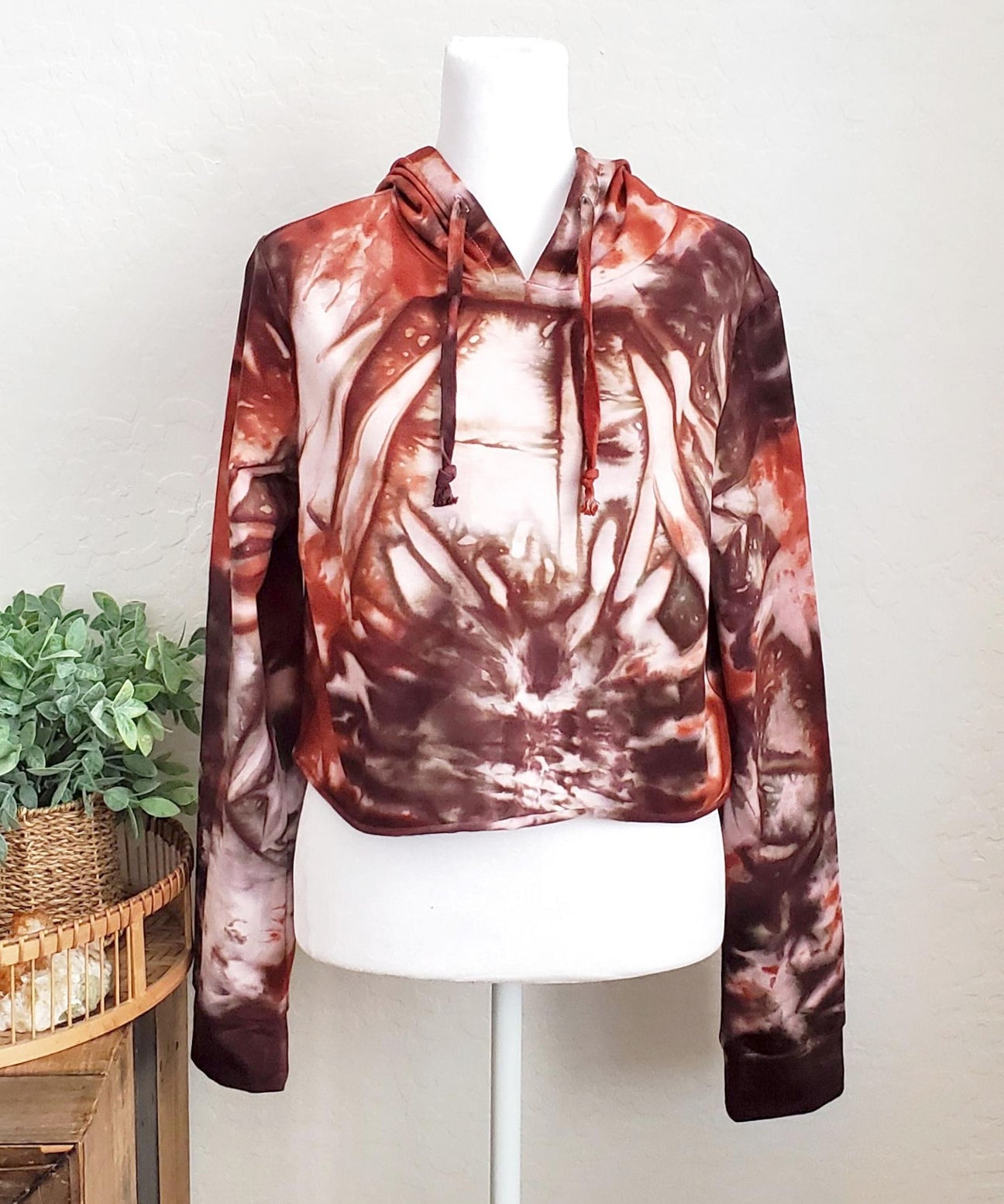 Rustic red and brown tie dye hoodie crop top with long sleeves.