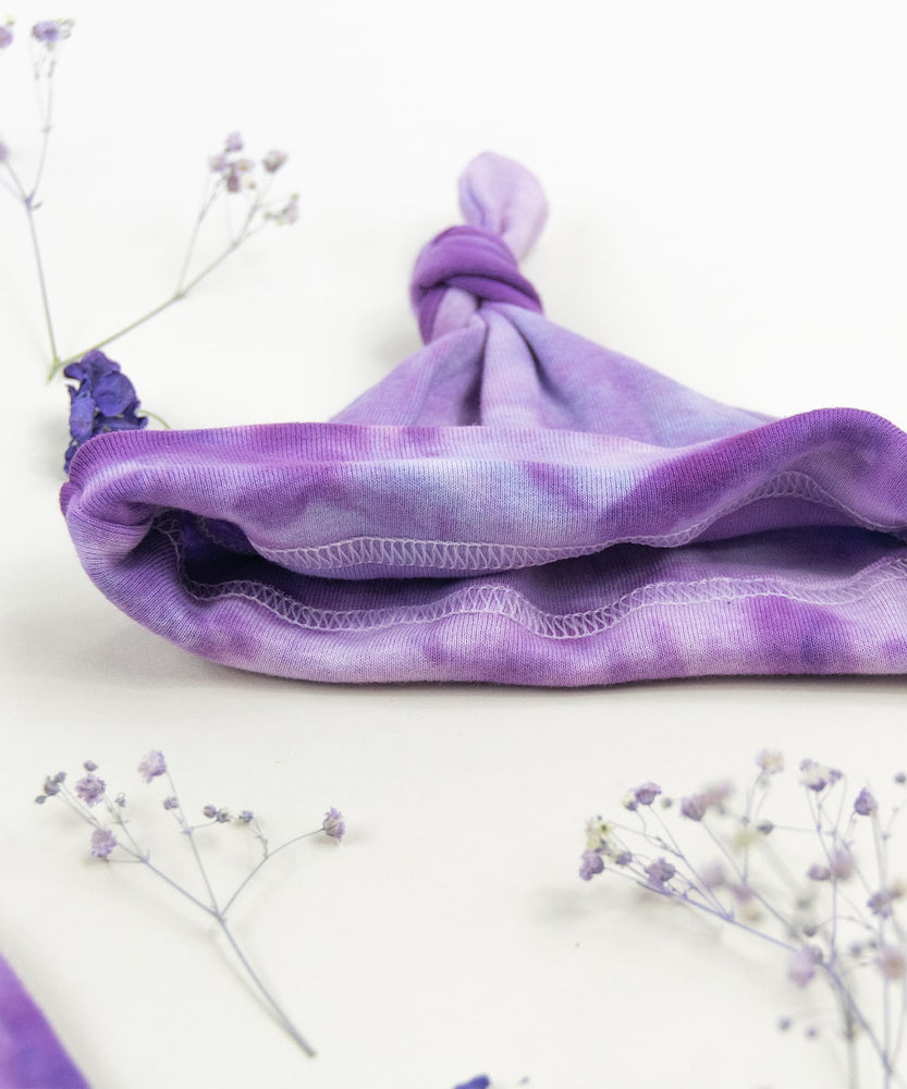 Purple organic cotton tie dye baby bodysuit and hat by Akasha Sun.