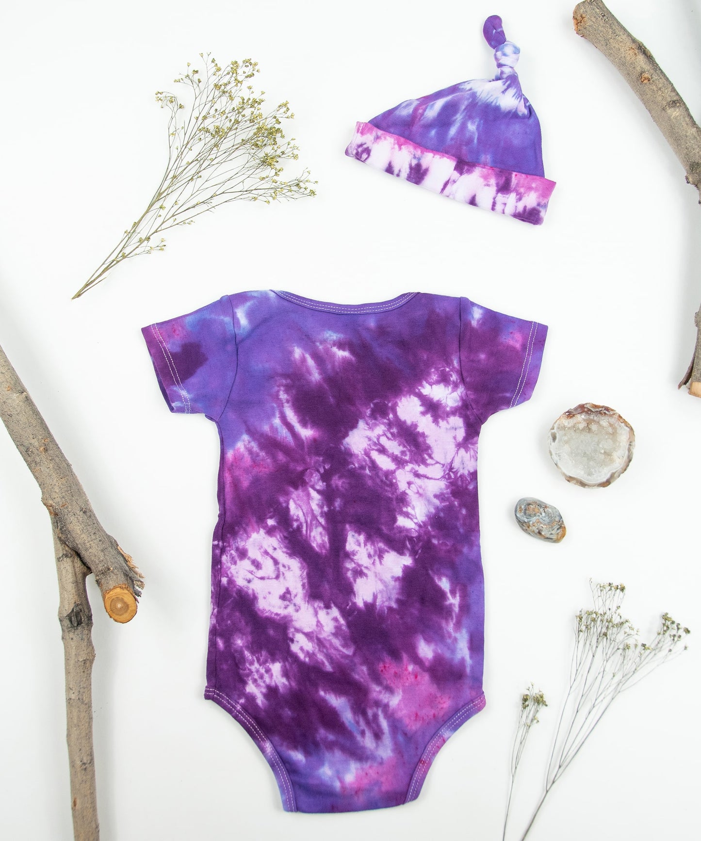 Purple tie dye bodysuit and baby hat set by Akasha Sun. Made of organic cotton.