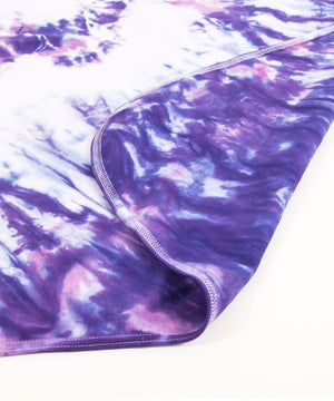 Pink and purple tie dye organic baby set that includes a baby blanket, onesie, and baby hat.