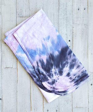 A periwinkle and black tie dye organic baby blanket with rounded corners.