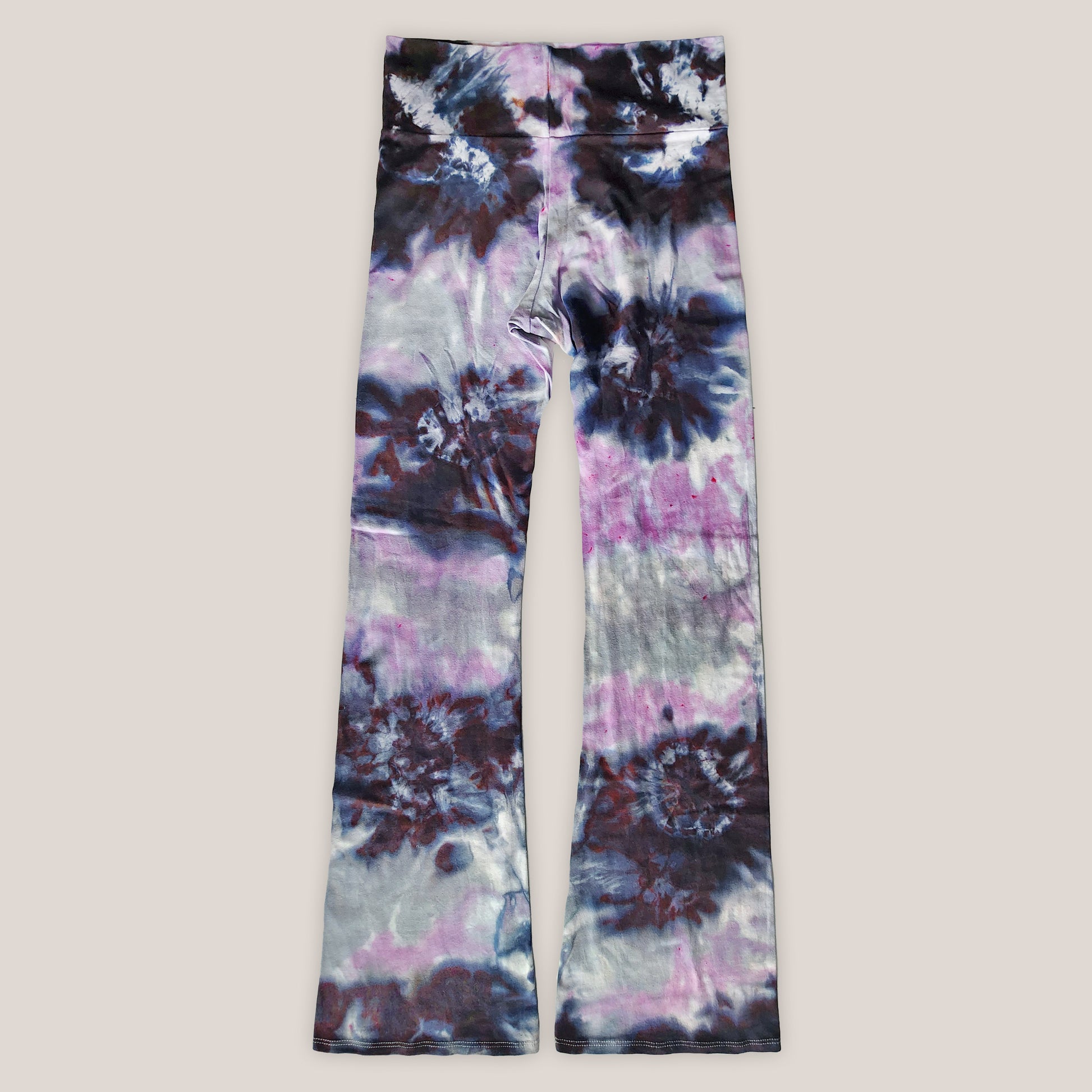 Tie-dye pants with a multicolor tie dye pattern on a plain background