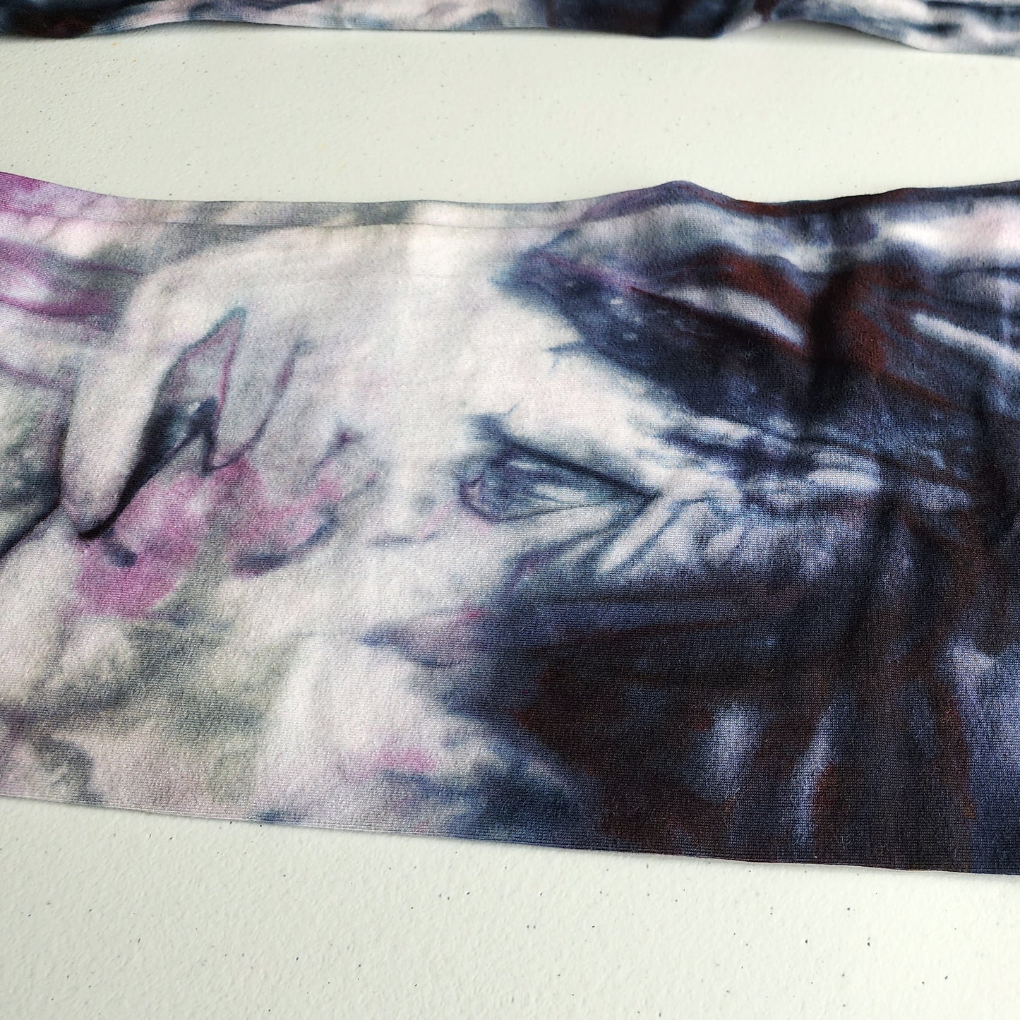 Close-up of a fabric with tie dye pattern on a white background