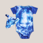 A blue and white tie dye baby bodysuit with a matching hat.