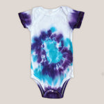 A purple and teal tie dye organic baby bodysuit.