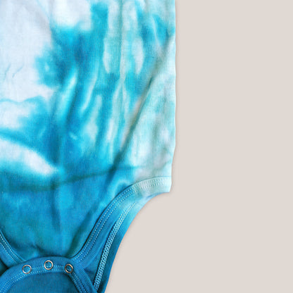 An organic aqua blue tie dye baby bodysuit and hat.