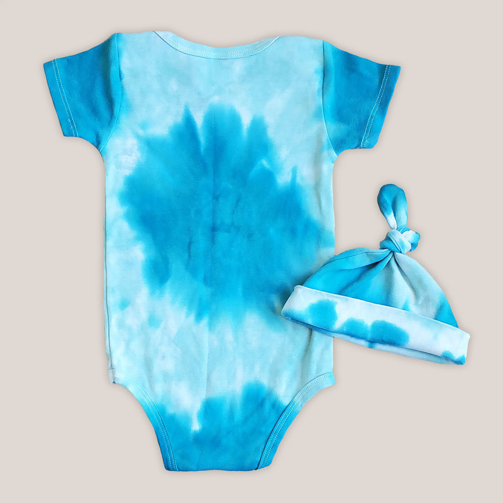 An organic aqua blue tie dye baby bodysuit and hat.