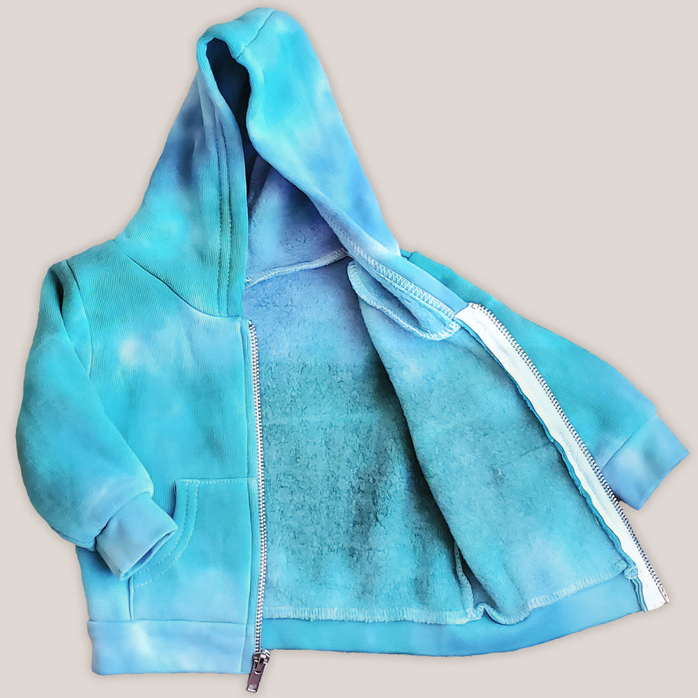 An aqua blue tie dye baby jacket with fleece interior, pockets, and hood.