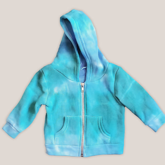 An aqua blue tie dye baby jacket with fleece interior, pockets, and hood.