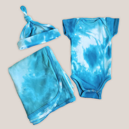 An organic tie dye baby bodysuit, hat, and blanket set in aqua blue.