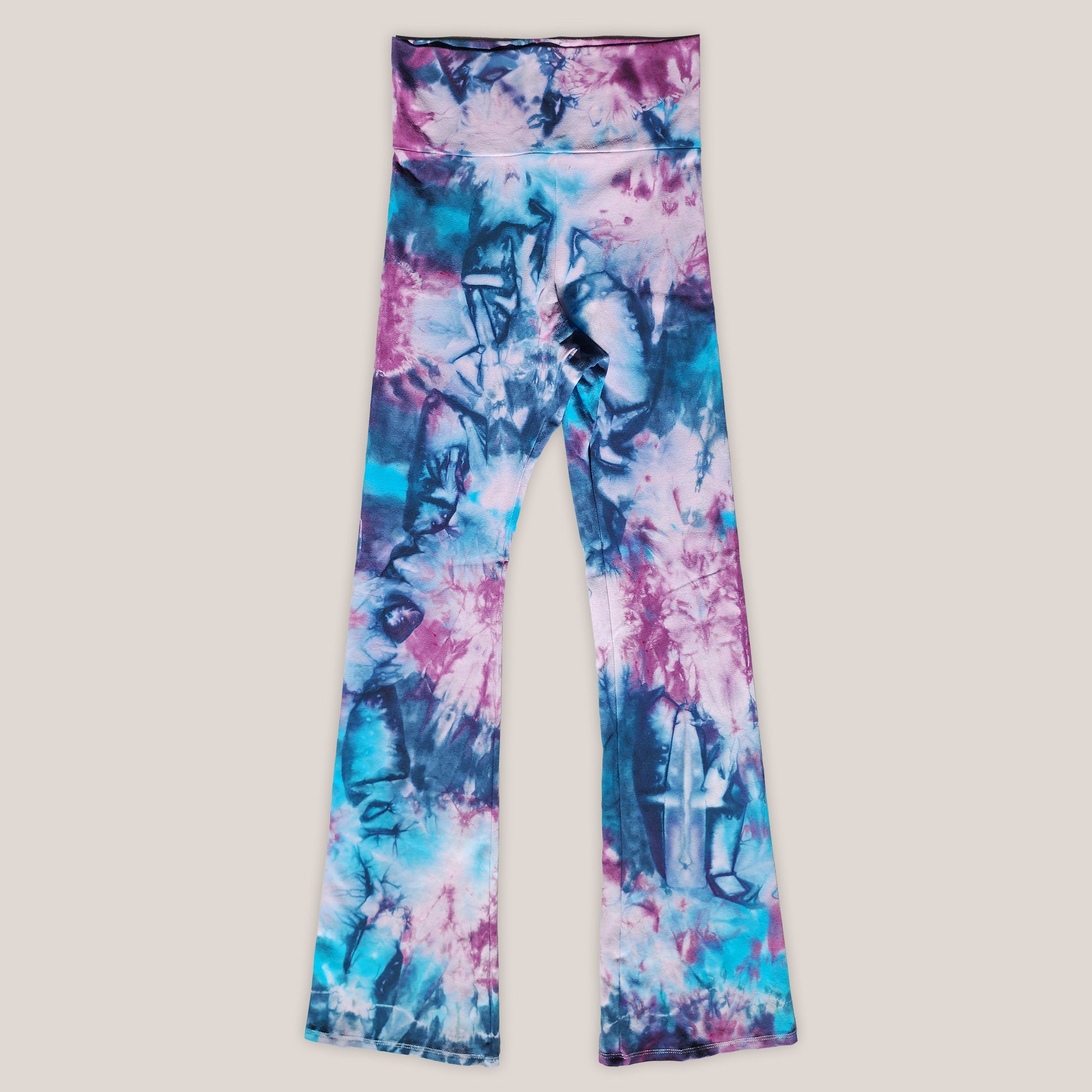 Colorful tie-dye leggings on a beige background