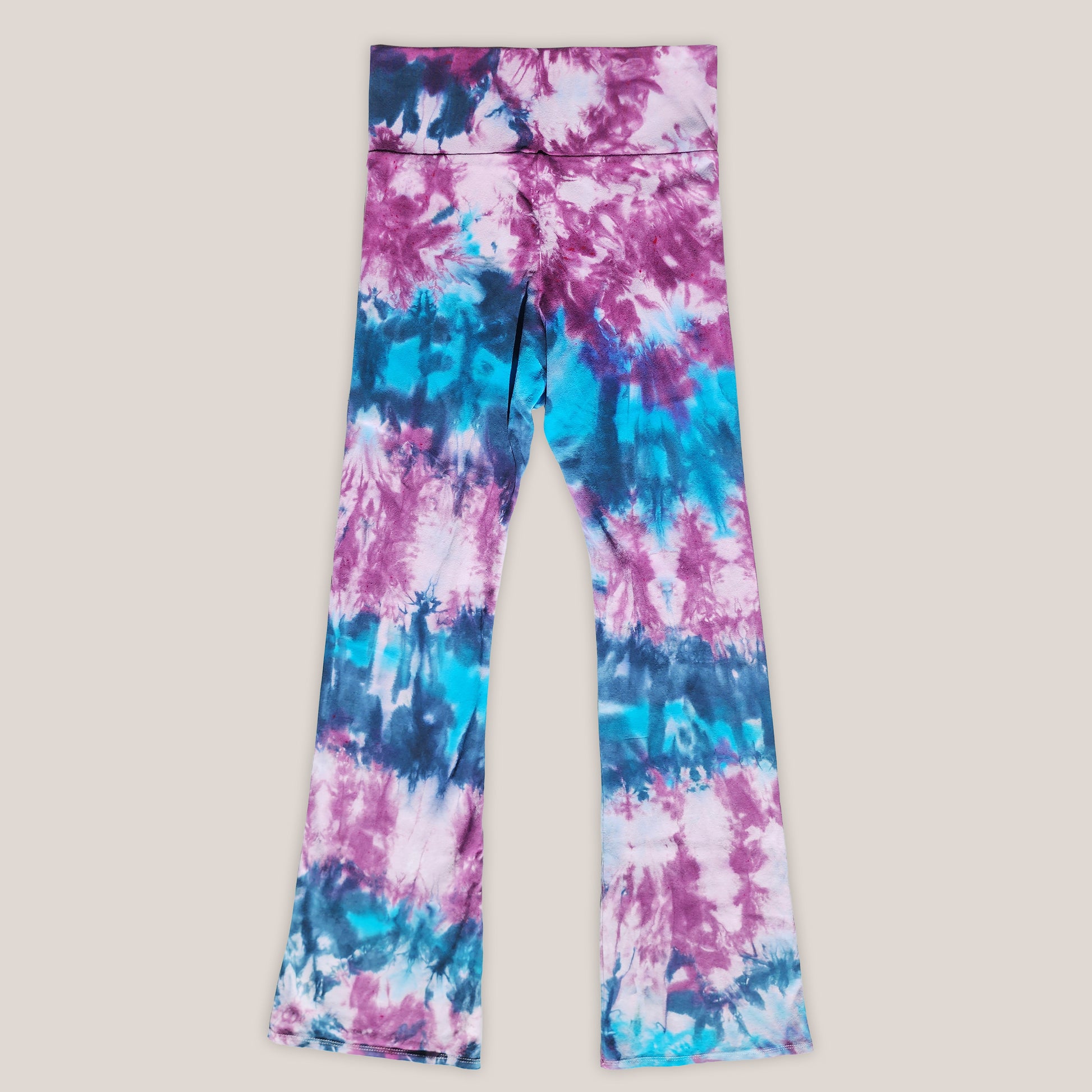 Tie-dye leggings with pink and blue patterns on a light gray background