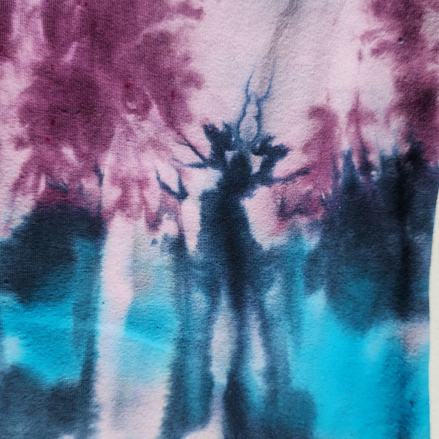Close-up of tie-dye fabric with purple and blue colors