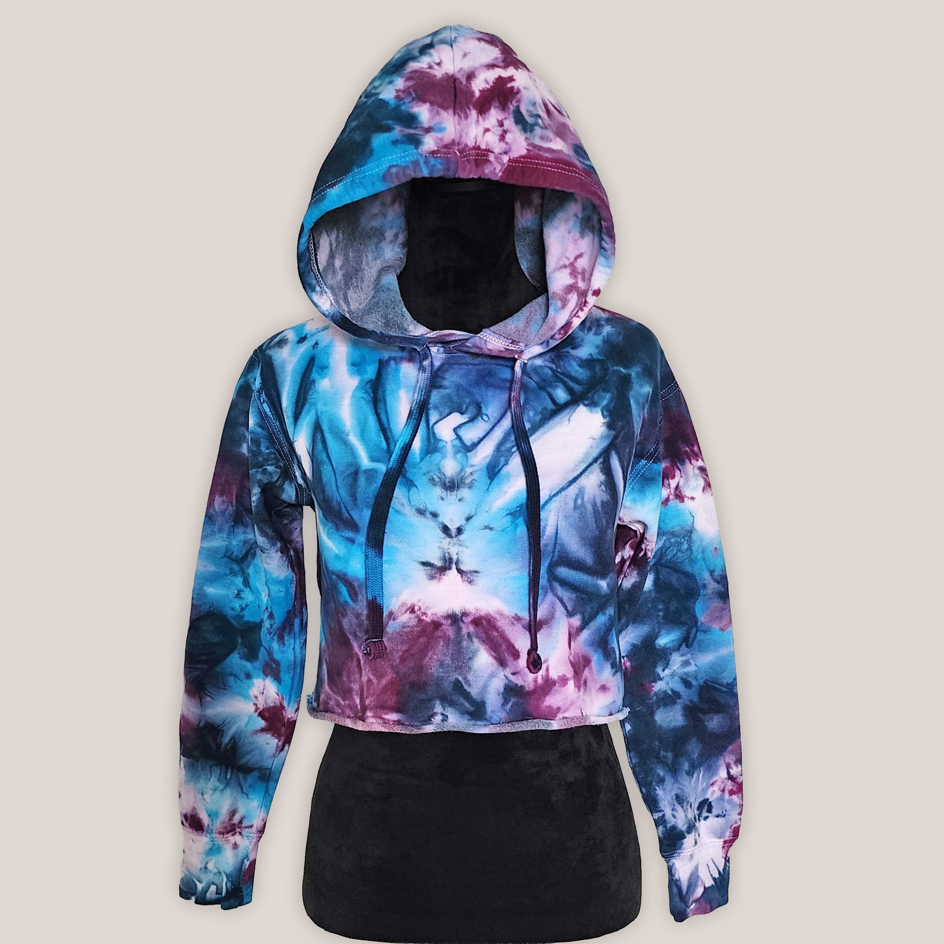 Colorful tie-dye hoodie on a beige background