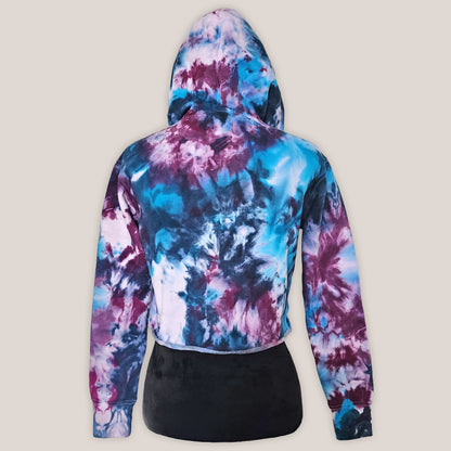 Tie-dye hoodie with a colorful pattern on a beige background