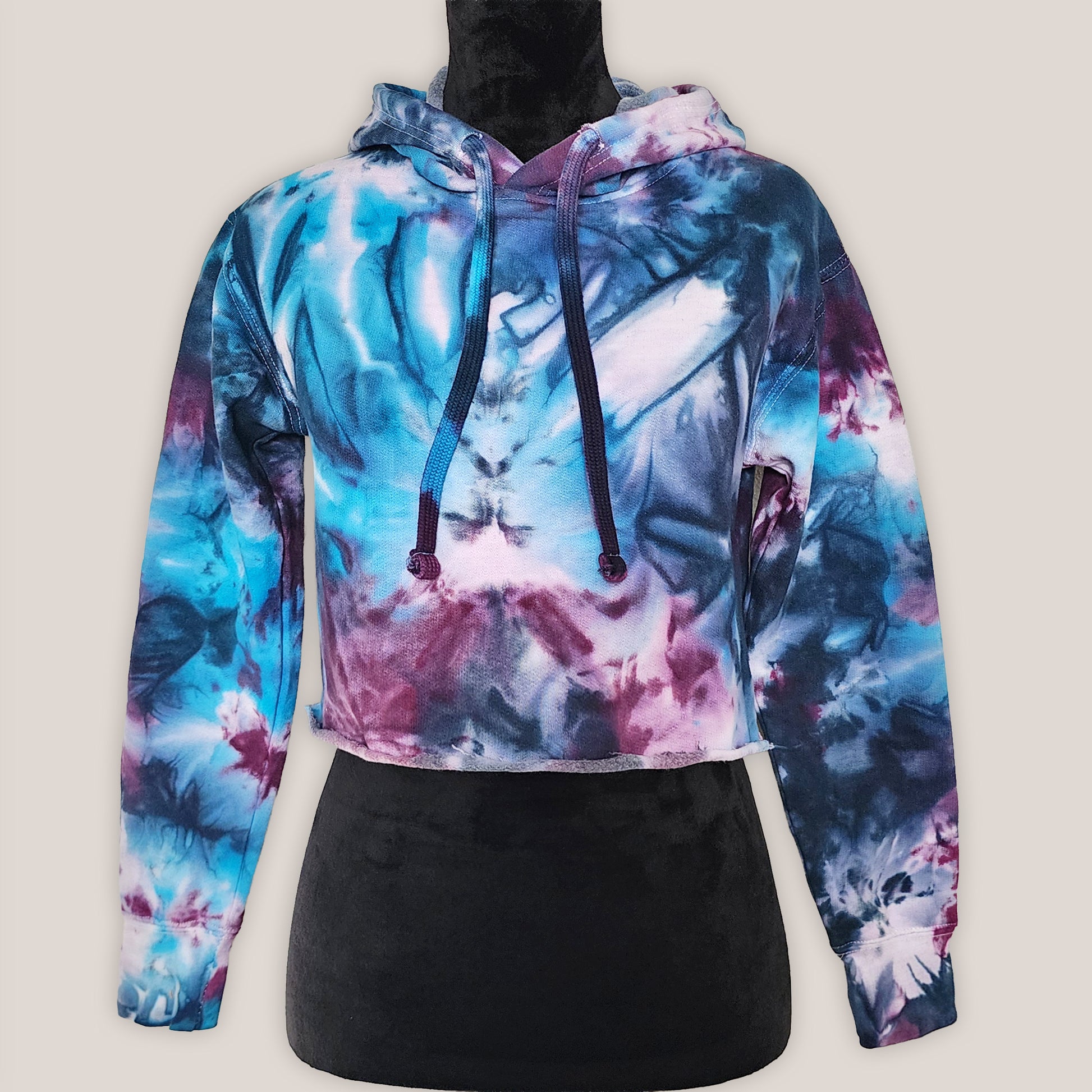 Multicolored tie-dye hoodie on a light gray background