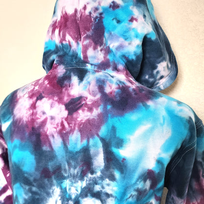 Multicolored tie-dye hoodie on a plain background