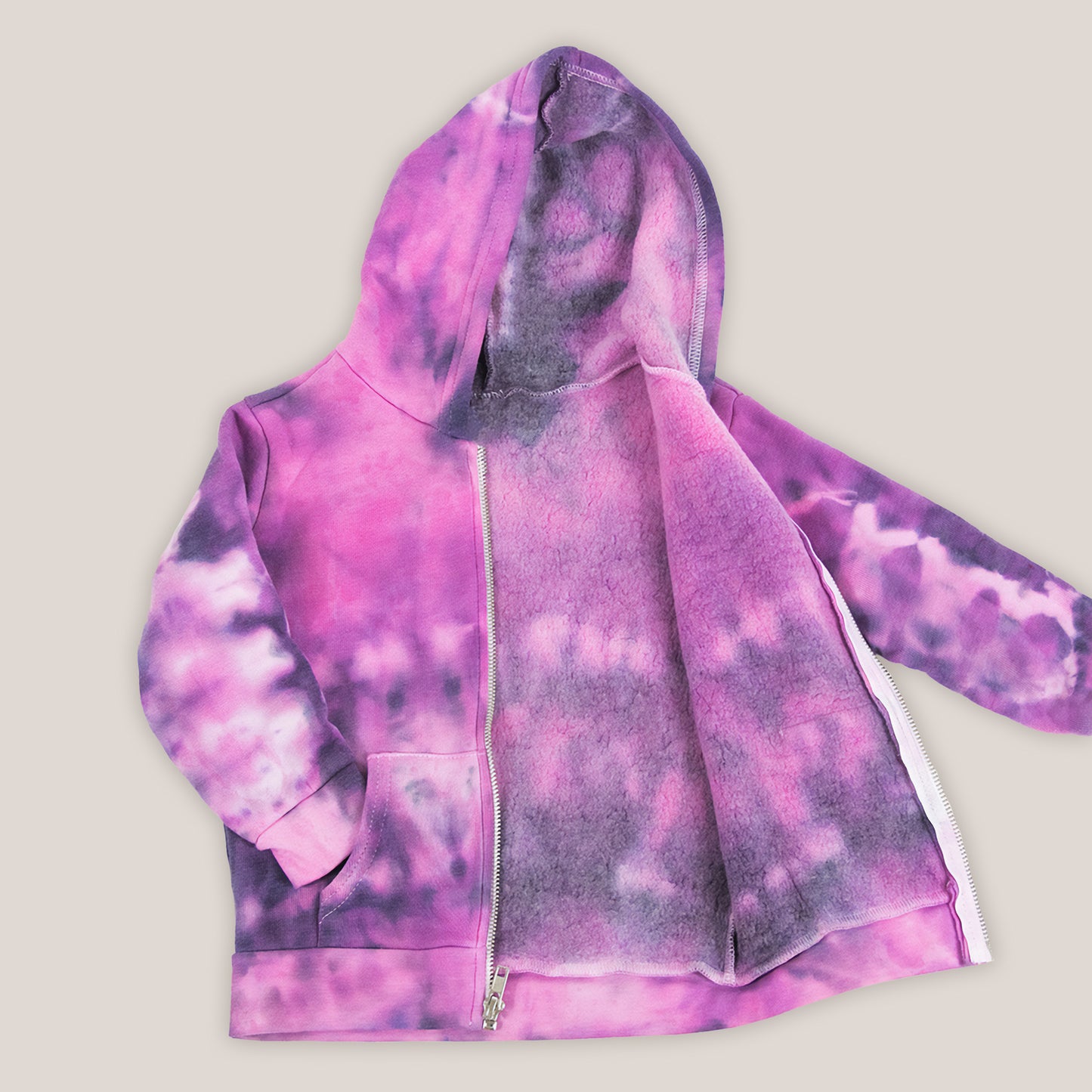 Pink and black tie dye toddler's jacket with a soft fleece interior, hood, pockets, and zipper.